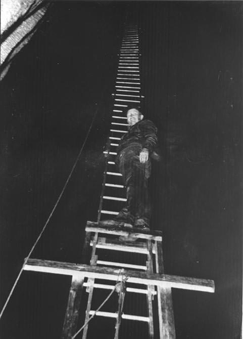 worker on ladder inside Ruby Falls